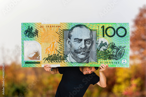 man holding a huge 100 Australian dollar paper money  photo