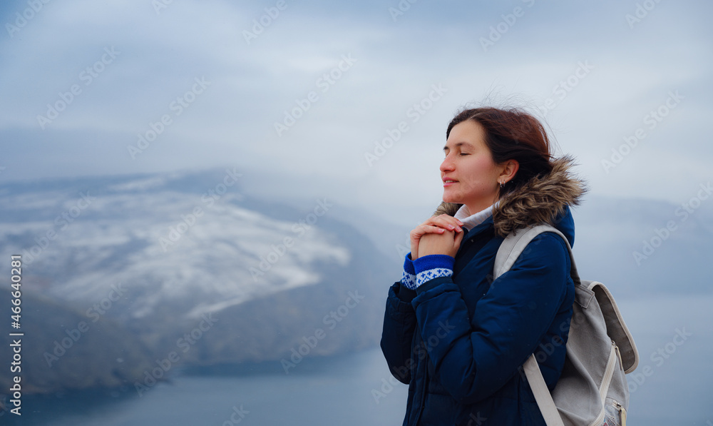 side view of woman in blue jacket and hat on shore of North sea on cold winter day. Mood Scandinavian weather. travel adventure lifestyle idea and concept side view of woman in blue jacket and hat on shore of North sea on cold winter day. Mood Scandinavian weather. travel adventure lifestyle idea and concept