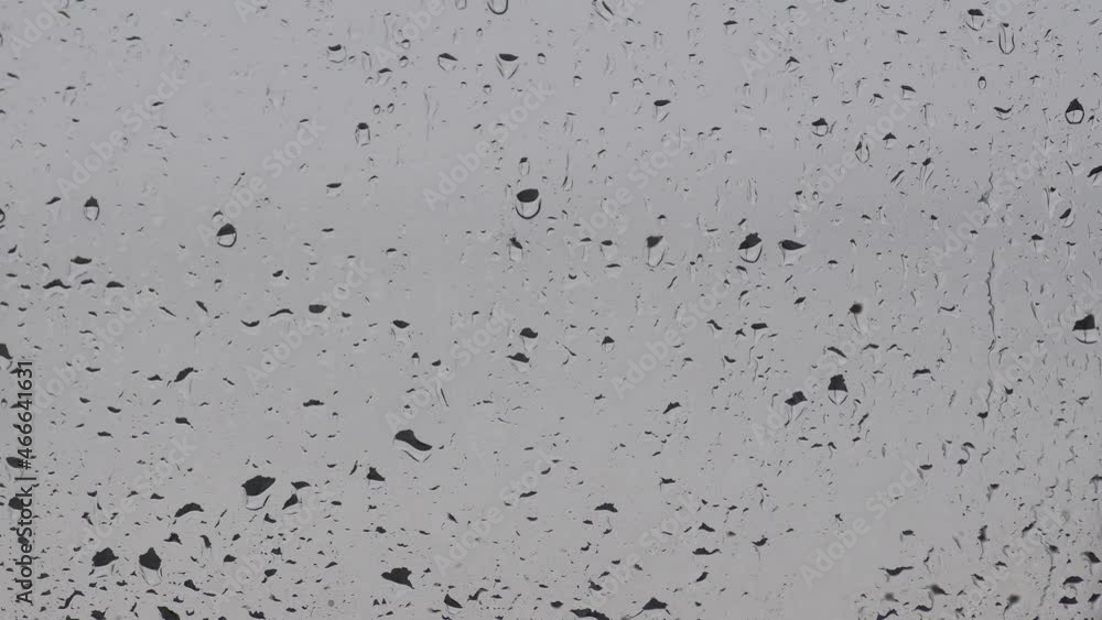 rain drops falling on transparent glass window rain drops falling on transparent glass window