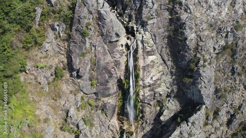 Aerial zoom in of natural waterfall named 