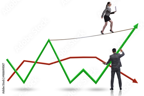 Businessman balancing on tightrope on line chart