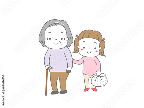 杖を突いて歩くおばあちゃんの荷物を持って手助けしている女の子