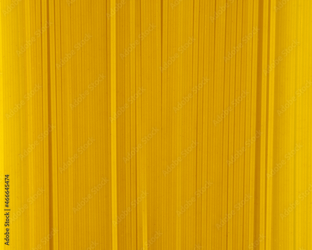 Obraz premium Uncooked spaghetti close-up background. Top view. Pasta. Background image of pasta from durum wheat.