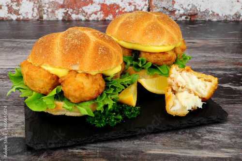 Photography Battered cod fish nugget sandwiches with mayonnaise and lettuce in crusty bread