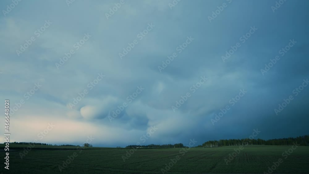 Mammatus storm clouds in summer evening sunset light Mammatus storm clouds in summer evening sunset light