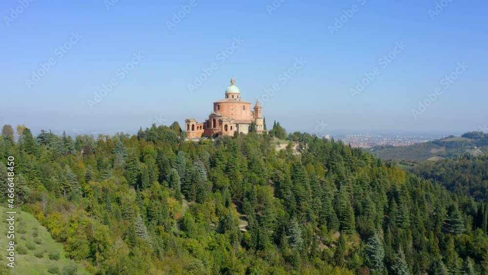 Sanctuary of the Madonna di San Luca, Bologna, Emilia-Romagna, Italy, October 2021. Drone gradually orbits the church from the southwest with the city in the distance. Sanctuary of the Madonna di San Luca, Bologna, Emilia-Romagna, Italy, October 2021. Drone gradually orbits the church from the southwest with the city in the distance.