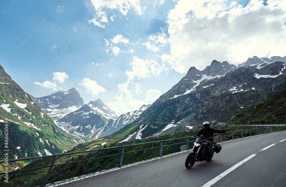 Moto trip. Lifestyle and travel. Beautiful landscape. A road through the Swiss Alps, Switzerland. Moto trip. Lifestyle and travel. Beautiful landscape. A road through the Swiss Alps, Switzerland.