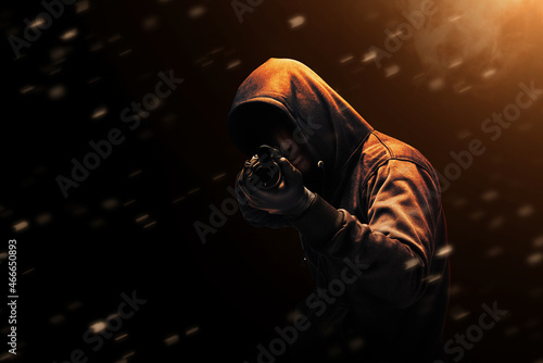 Canvas Print Criminal man in hidden mask pointing the shotgun