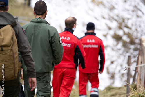 Crew of Swiss Army rescue helicopter at Axalp, Canton Bern, air show of Swiss Air Force on a cloudy grey autumn day. Photo taken October 19th, 2021, Brienz, Switzerland.