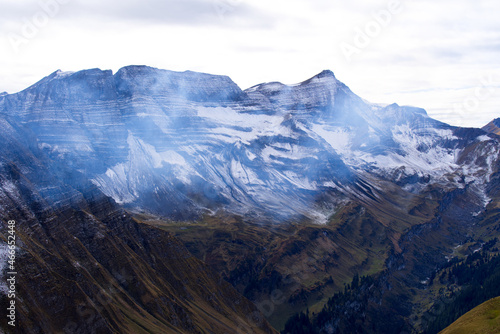 Mountain panorama with fresh snow seen from Axalp at Bernese Highlands on a grey cloudy autumn day. Photo taken October 19th  2021  Brienz  Switzerland.