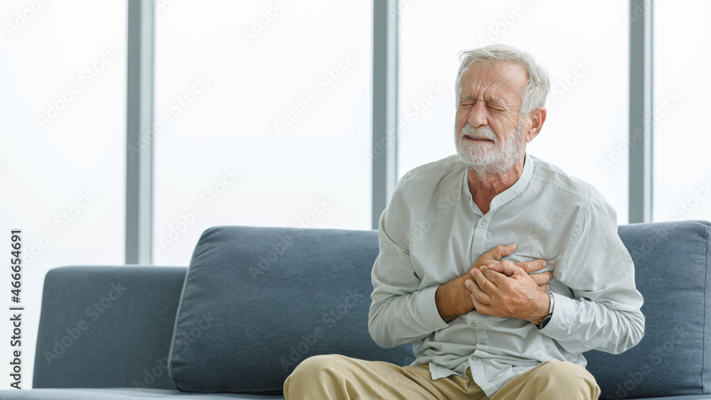 Caucasian old senior elderly unhealthy sick ill male husband grandpa sitting on sofa at home alone holding hands on chest having emergency cardio problem suffering from urgent heart attack disease Caucasian old senior elderly unhealthy sick ill male husband grandpa sitting on sofa at home alone holding hands on chest having emergency cardio problem suffering from urgent heart attack disease
