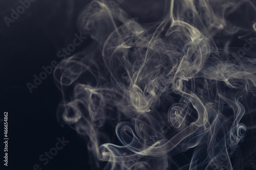 White smoke in front of the black background. 