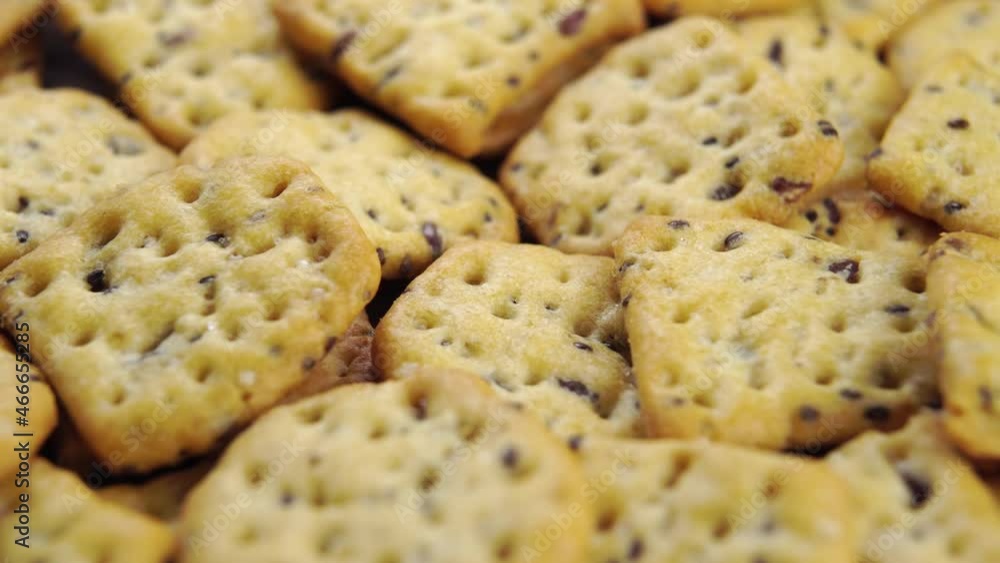 Grain salted crunchy crackers with flax seeds. Rotation. Macro Grain salted crunchy crackers with flax seeds. Rotation. Macro