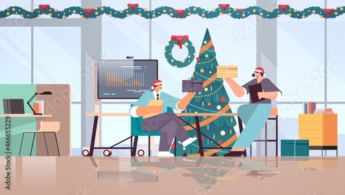 business people in santa hats holding gifts businesspeople celebrating corporate party new year christmas holidays celebration