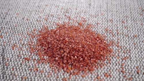 Red Hawaiian sea salt crystals on a rustic rough jute surface. Close up. Rotation photo