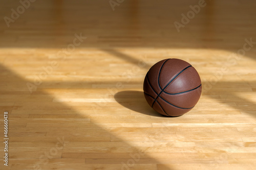 Basketball court wooden floor with professional brown leather ball and shadows. Horizontal sport poster, greeting cards, headers, website