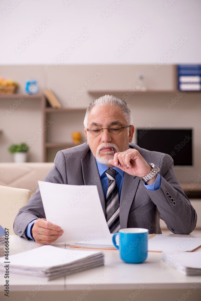 Old male employee working from home during pandemic Old male employee working from home during pandemic