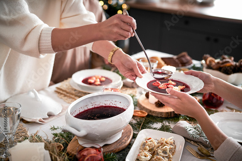 Fotografie Family start eating traditional Polish soup at Christmas Eve