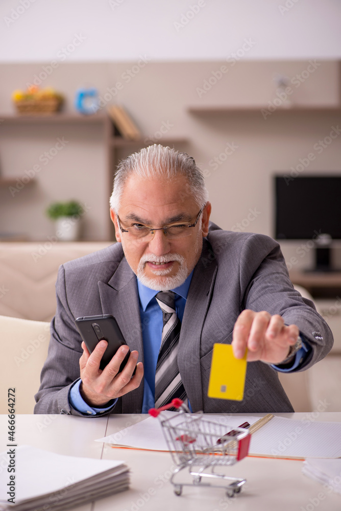 Old male employee in e-commerce concept during pandemic Old male employee in e-commerce concept during pandemic