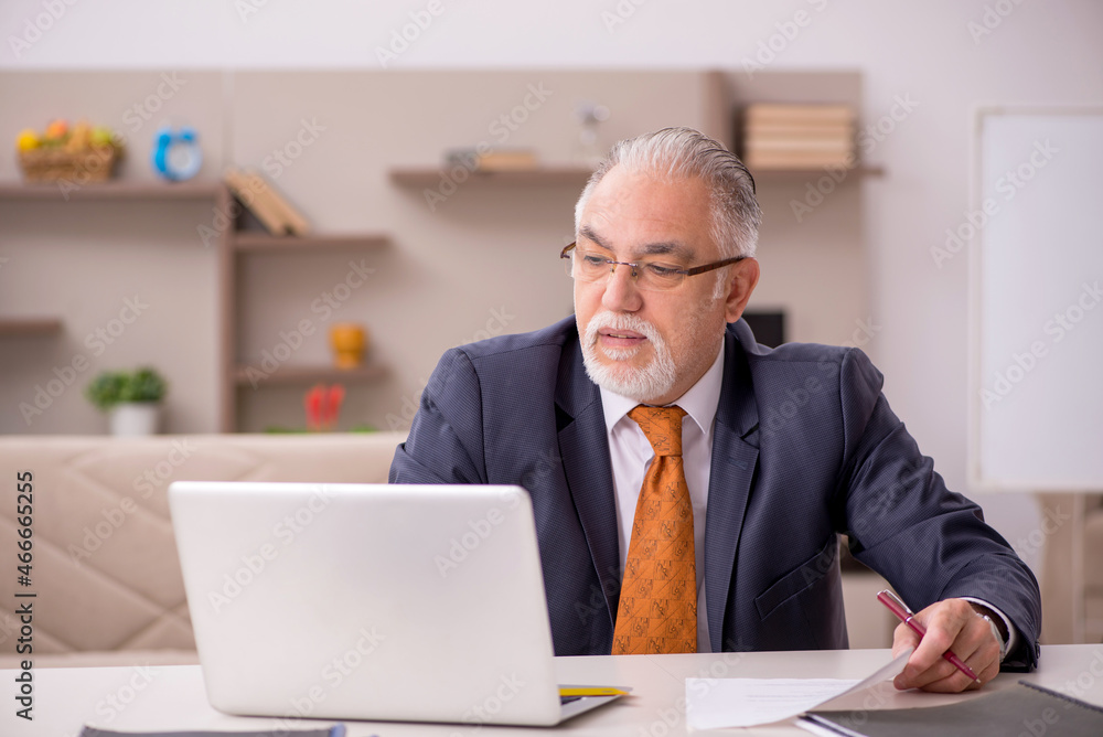 Old male employee working from home during pandemic Old male employee working from home during pandemic