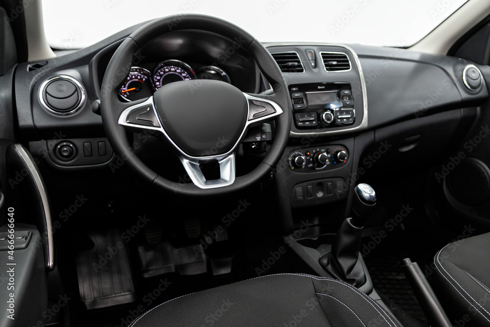 Black luxury car Interior - dashboard, player, steering wheel and buttons, speedometer and tachometer.