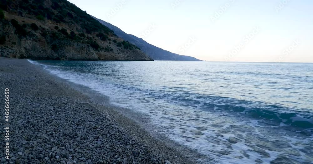 beach and sea among mountains, waves with white foam beach and sea among mountains, waves with white foam