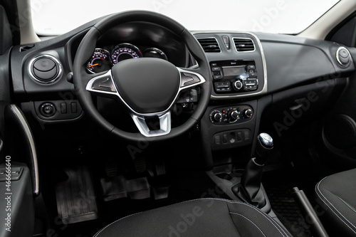 Black luxury car Interior - dashboard, player, steering wheel and buttons, speedometer and tachometer.