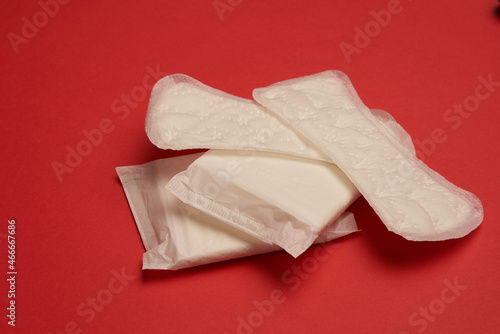 pads tampons underwear feminine hygiene red background