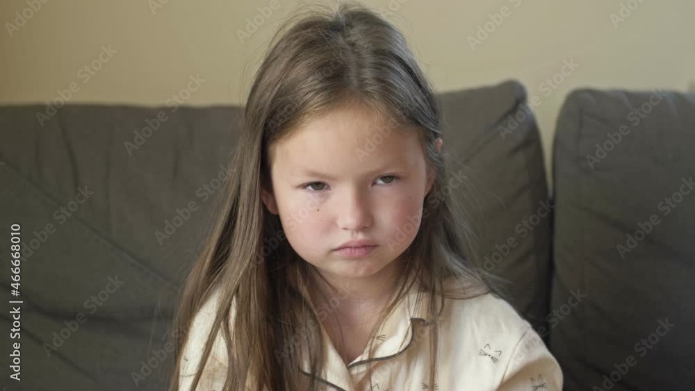 Portrait of a girl in pajamas 6-7 years old who just woke up. Child rubs his sleepy eyes. Portrait of a girl in pajamas 6-7 years old who just woke up. Child rubs his sleepy eyes.