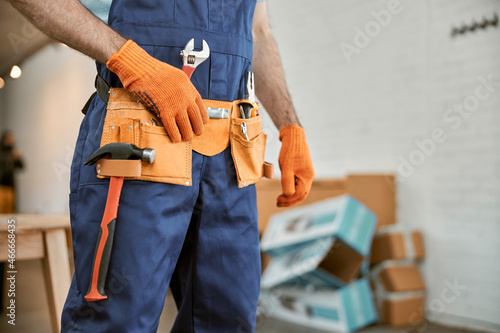Photos Male worker wearing tool belt with instruments
