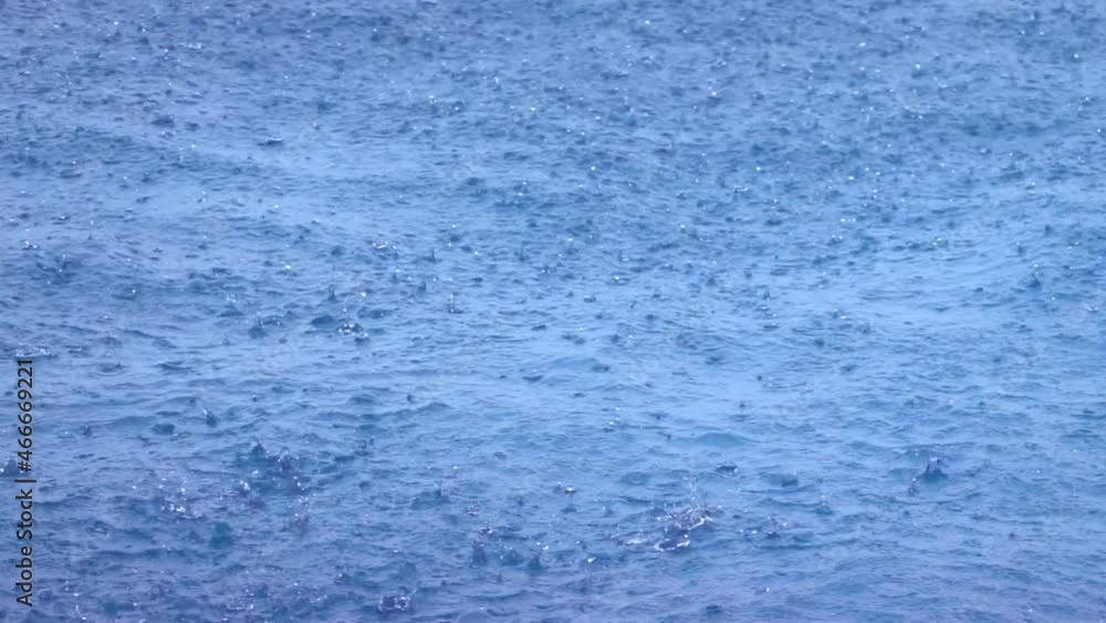 Raindrops on the waters' surface causing small splashes. Raindrops on the waters' surface causing small splashes.