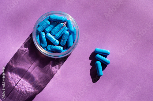 Wallpaper Mural Blue capsules in transparent packaging on a purple background. Reflection of glass in the sun. Health care pills.  Torontodigital.ca