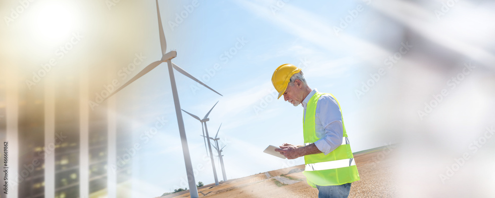 Engineer using digital tablet for wind turbine inspection; multiple exposure
