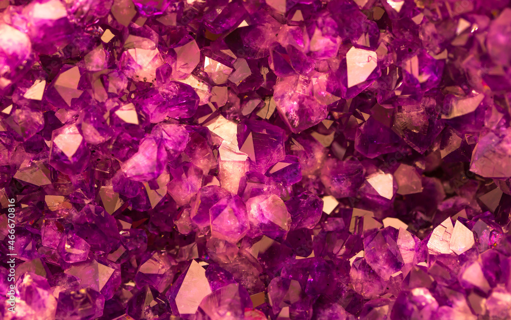 Amethyst pink crystals. Gems. Mineral crystals in the natural environment. Texture of precious and semiprecious stones. Seamless background with copy space colored shiny surface of precious stones. Amethyst pink crystals. Gems. Mineral crystals in the natural environment. Texture of precious and semiprecious stones. Seamless background with copy space colored shiny surface of precious stones.