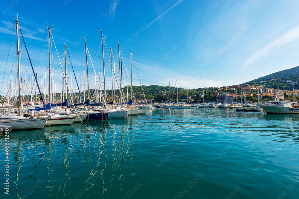 Large group of sailing boats moored in the port of the small village of Lerici, tourist resort on the coast of Gulf of La Spezia, Mediterranean sea, Liguria, Italy, Southern Europe.