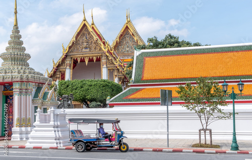 Photography Tuk tuk driver waiting outside the Grand Palace in downtown Bangkok Thailand