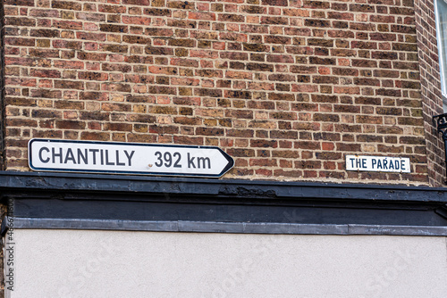 Sign on a wall in Epsom town centre, UK, which  twinned with  a French town Chantilly, 392 km away. photo