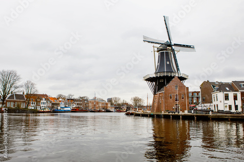 Cityscape of Haarlem, the Netherlands. View of old windmill and typical Dutch houses.