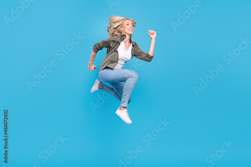Full length body size photo woman jumping running on sale isolated pastel blue color background
