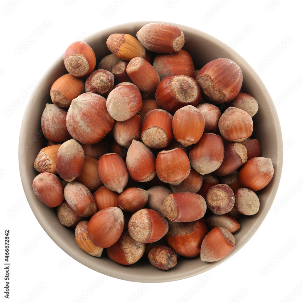 Ceramic bowl with hazelnuts isolated on white, top view. Cooking utensil