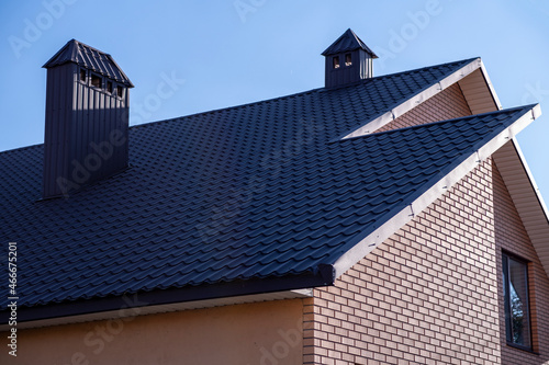The roof is made of brown metal tiles.