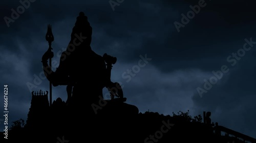 Hinduism Temple with Lightning and thunderstorm flash over Lord Shiva God in Silhouette photo