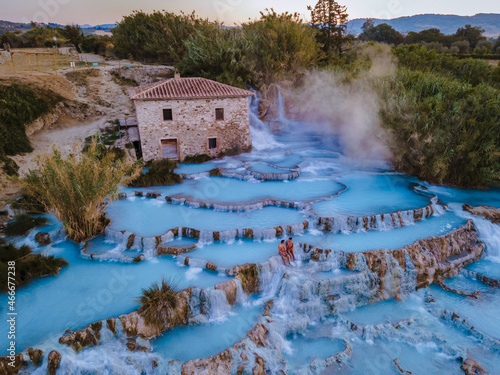 Toscane Italy, natural spa with waterfalls and hot springs at Saturnia thermal baths, Grosseto, Tuscany, Italy aerial view on the Natural thermal waterfalls couple at vacation at Saturnia Toscany photo