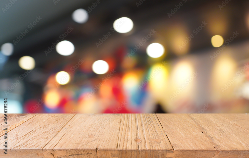 Empty wooden table in front of abstract blurred background of coffee shop . can be used for display or montage your products.Mock up for display of product Empty wooden table in front of abstract blurred background of coffee shop . can be used for display or montage your products.Mock up for display of product