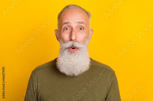 Photo of impressed aged grey beard man wear green sweater isolated on yellow color background