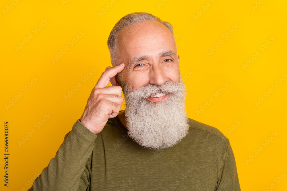 Fototapeta premium Photo of clever smart grandpa toothy smile finger temple wear green shirt isolated yellow color background