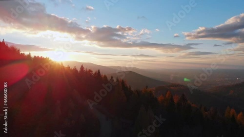 Epic cinematic beatiful and smooth fly above autumn forest mountains and Bielsko-Biała city. Tilt up. 