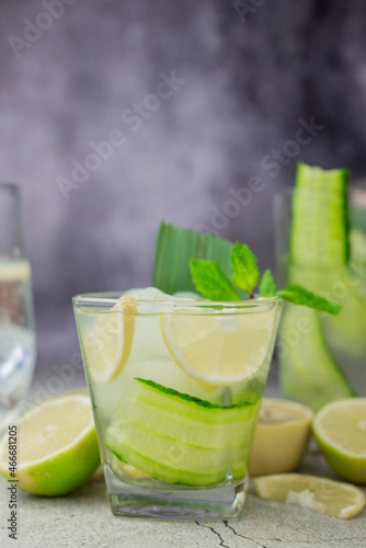 cocktail drink alcoholic with green cucumber and tonic with lime