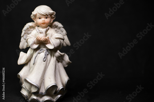 angel figurine on a black background