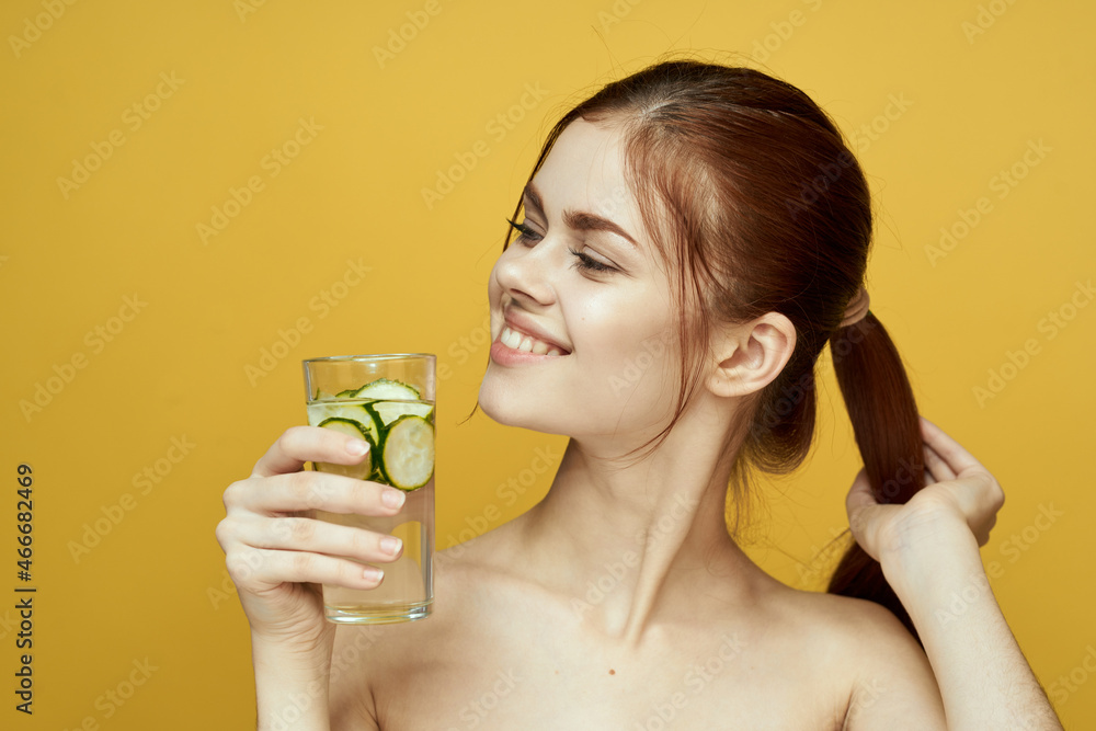 woman with cucumber drink vitamins body care yellow background woman with cucumber drink vitamins body care yellow background